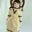 Laden Sie das Bild in den Galerie-Viewer, Puppe mit braun beigen Kleid / Porzellankopf & Stoffkörper / ca. 45 cm
