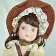 Laden Sie das Bild in den Galerie-Viewer, Puppe mit braun beigen Kleid / Porzellankopf & Stoffkörper / ca. 45 cm